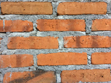 Red brick wall mounted on the wall of the houseの写真素材