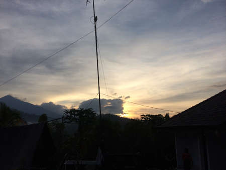 cloud-covered morning sun with a mountain viewの写真素材