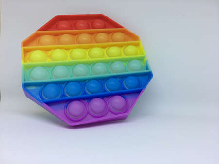 Rainbow Pop it fidget toy isolated on a white background. Fidget popper, anti anxiety and stress...