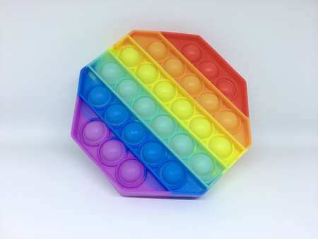 Rainbow Pop it fidget toy isolated on a white background. Fidget popper, anti anxiety and stress relief gameの写真素材