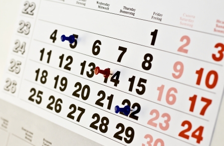 White paper calendar with red and blue appointment pinsの写真素材