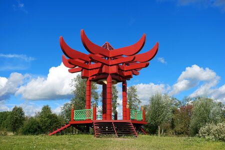 gazebo. Red Pagoda. green grass and blue skyの写真素材