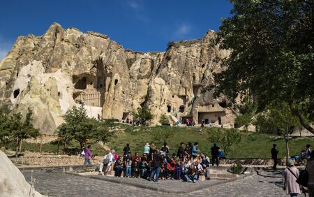 Cappadocia, Turkey - April 29, 2014: Tourists visiting Cave Church at Goreme in Nevsehir. Group of tourists listening to the guide.のeditorial素材