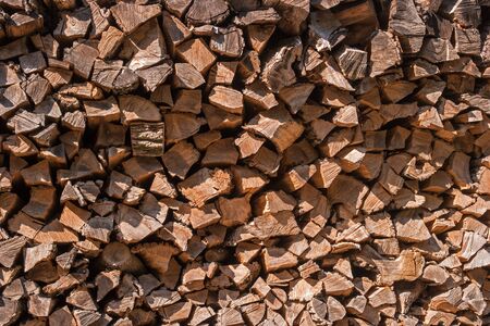 Stocks of wood as a background. Stacked firewood pattern