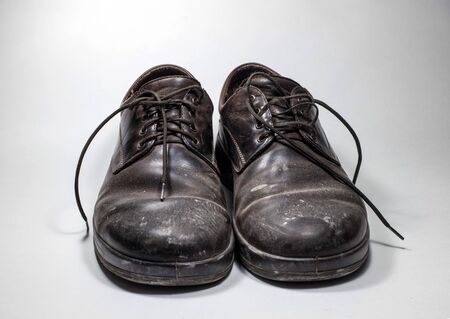 Dirty men's shoes sprinkled with whitewash. Shoes on a white background.の写真素材