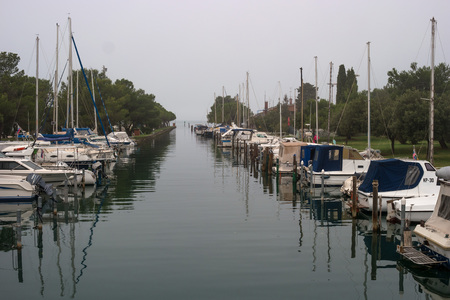 Portoroz, Slovenia - October 17, 2016: Yachts and boats at the marina. Lyricism photos gives an early autumn morning fog.のeditorial素材