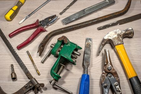 Old tools on wooden background.