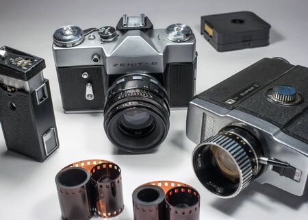 Gatchina, Russia - January 15, 2017: Retro camera and camcorder. Photographed on a bright background.のeditorial素材