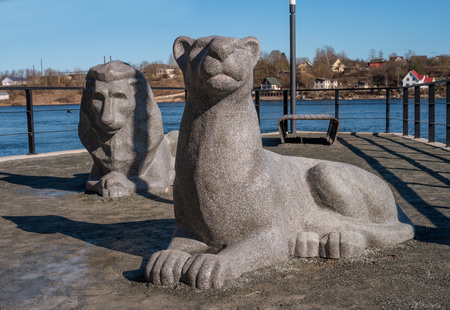 Narva, Estonia - March 16, 2017: Sculptural group -Lions- on the promenade along the Narva River. Sculpture symbolizes semicity, tradition and care for children. People walk and take pictures with stone lions.のeditorial素材