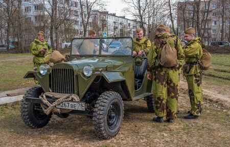 Gatchina, Russia - May 7, 2017: Historical reconstruction of the battles of World War II. Soviet soldiers in camouflage suits near a military jeep GAZ 67B.のeditorial素材