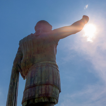 Monument to Roman emperor Constantine I in Milan, in front of San Lorenzo Maggiore basilica. This bronze statue is a modern copy of a Roman statue in Rome. Backlit photoの写真素材
