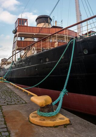 Tallinn, Estonia - November 18, 2018: Suur Toll icebreaker at the pier. The icebreaker steamer is part of the Tallinn Maritime Museum. There is a mooring bollard on the front.のeditorial素材