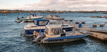 Tallinn, Estonia - November 18, 2018: Parking of small vessels, yachts in the Summer harbor at the Maritime Museum of Estonia. In the background is the seaport of Tallinn. Sea port cranesのeditorial素材