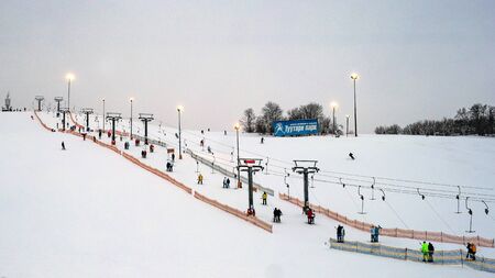 St. Petersburg, Russia, Tuutary Park - January 07, 2019: Ski slope and ski lift. Evening time. Lanterns illuminate the slope. Tuutari Park is located in the south of St. Petersburg.のeditorial素材