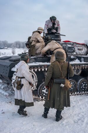 Krasnoye Selo, St. Petersburg, Russia - January 19, 2019: Military historical reconstruction - the battle for Leningrad. Tank PzKpfw III is preparing for battle. The tank has German soldiers.のeditorial素材