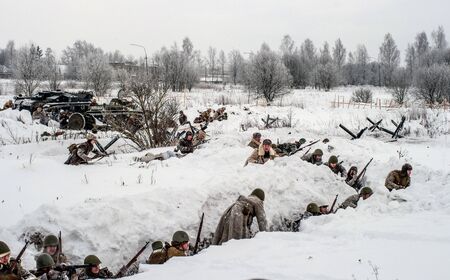Krasnoye Selo, St. Petersburg, Russia - January 19, 2019: Military historical reconstruction - the battle for Leningrad. The soldiers of the Soviet Army in the trenches are preparing for an attack.のeditorial素材