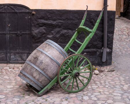 Trolley for transporting wooden barrels. Wooden barrel on a trolley. Old cart. Old barrel.の写真素材