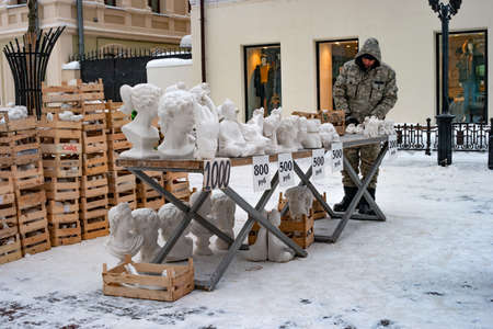 Kazan, Russia - January 08 2021: Street vendor of sculptures on a pedestrian street. Bauman street in the historical part of the city. Winter dayのeditorial素材