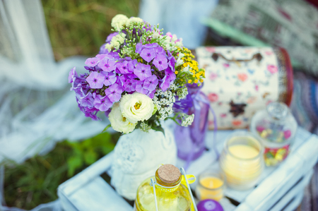 bouquet of purple flowers in a white vase in natureの写真素材