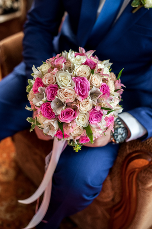 The groom holds a bouquet for the bride. view from aboveの写真素材
