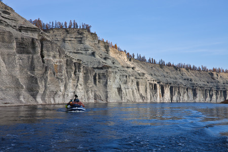 Boat with cargo and a dog on the Siberian river. Moiyero river, Evenkia, Krasnoyarsk region, Russiaのeditorial素材