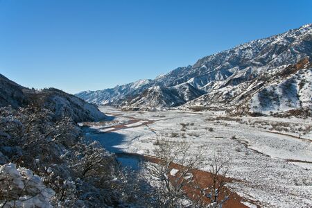 Gorge Sarihosor and Surkhob river after a snowfall in December. The upper reaches of the river Vakhsh (Surkhob) in winter.の写真素材