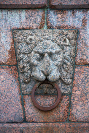 Granite lion with a metal ring for mooring. Embankment of Vasilyevsky island in St. Petersburg. Russiaの写真素材