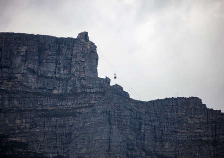 View of Table mountain and the tourist lift in cloudy weather in Cape town. Africa,