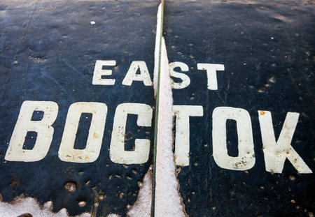 Direction sign   words "EAST" and "EAST" in Latin and Cyrillic.の写真素材