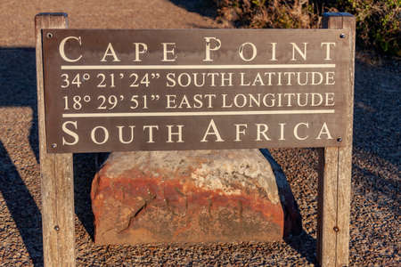 Cape Point 34 degrees 21 minutes 24 seconds south latitude 18 degrees 29 minutes 51 seconds east longitude South Africa. The inscription on the information stand about the geographical coordinates of the Cape of Good Hope in southern Africa.の写真素材