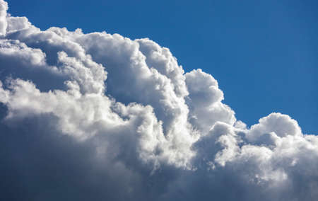 Heavenly cloudy landscape against blue summer sky. Typical cumulus cloud in the form of mountain in clear weatherの写真素材