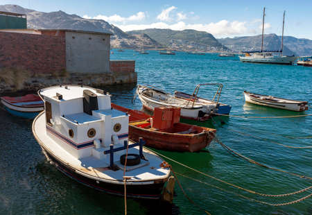 Fishing and pleasure motor and rowing boats on the water at the pier. Yachts and boats of various sizes and purposes anchored and moored in the sea Bay.の写真素材