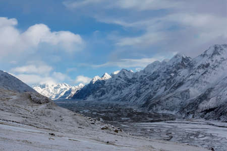 View of the Mirzbacher glacier in the upper part of the Enelchek River valley. A gorge with the lower part of a glacier in the mountains in winter.の写真素材