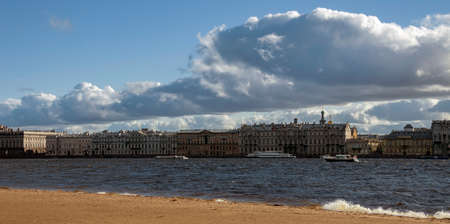 Neva River in autumn on windy day with beautiful clouds over the Palace Embankment. Urban sky and...