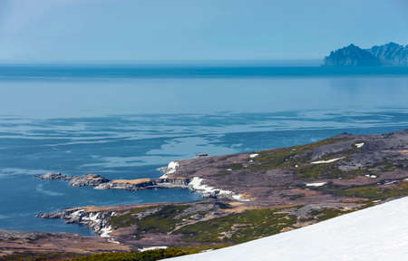 Landscape with coastal tundras in the Penzhinskaya Bay of the Sea of Okhotsk at rising tidal water...