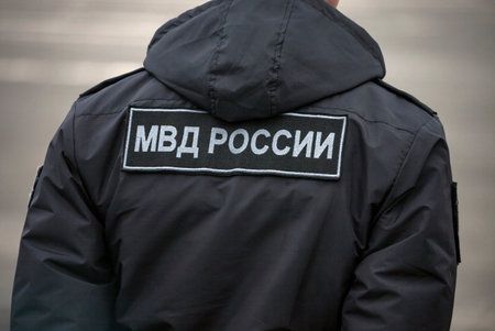 Ministry of Internal Affairs of Russia - the inscription on the back of policeman in Cyrillic. Patch...