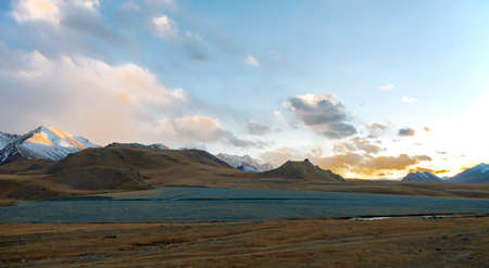 Autumn sunset over mountain pass in the high mountains. Sky and stone landscape in the evening twilight in Central Asia.の写真素材