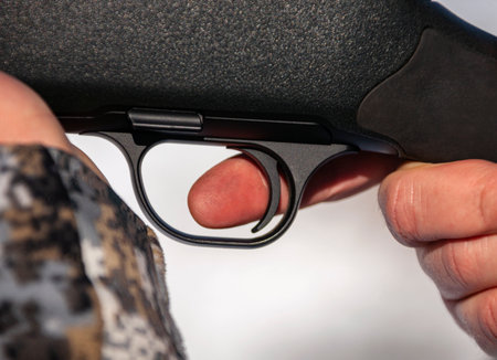 Shooter's index finger is on the trigger of handgun. Finger on the trigger before firing.