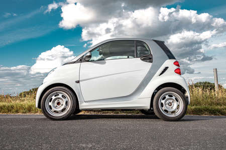 Duelmen, Germany - 06 28 2020:  Smart 451 ED electric drive car on a country road, side view onto...