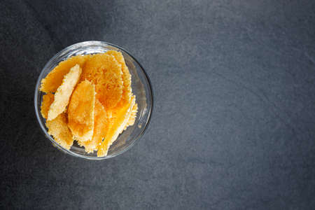 Top view of parmesan cheese cracker chips an a glas bowl, this is a simple easy snack for party or...