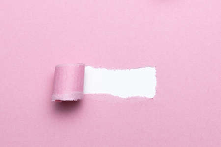 Breach or peeled of paper for hidden text used as template or mockup on pink natural paper, use for compositions and easy to colorの写真素材