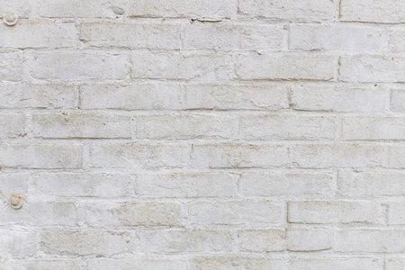 Texture shot of a white weathered brick wall with thick white paint, small dents and scratches with some degree of grunge and dirt, use for game model texture or referenceの写真素材