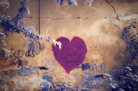 Lviv, Ukraine, July 15 2019, Heart graffiti on a wall with branchesのeditorial素材