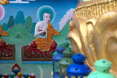 Painting at the foot of the large Buddha statue at the Tibetan Buddhist institute Kagyu Yeunten Gyamtso Lingの写真素材
