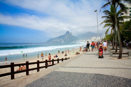 RIO DE JANEIRO - JANUARY 2013 - People walk on  Ipanema beach along seafront