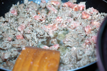 Ground meat on frying pan in time of fryingの写真素材