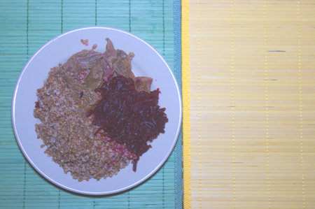 goulash with buckwheat and beets on plateの写真素材