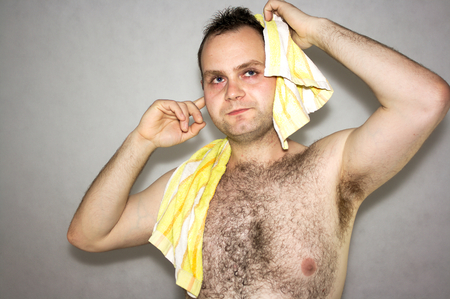 Man dries head towel on whiteの写真素材