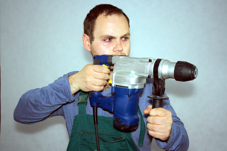 Man of worker and hammer drill の写真素材
