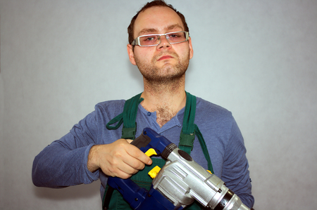 Man of worker and hammer drill の写真素材